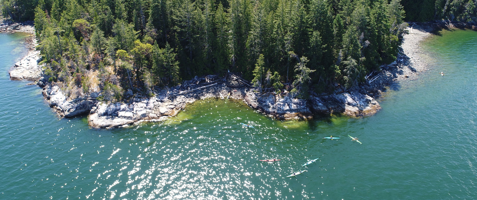 Kayaks in the water near Kinghorn Island on one of our Desolation Sound camping tours