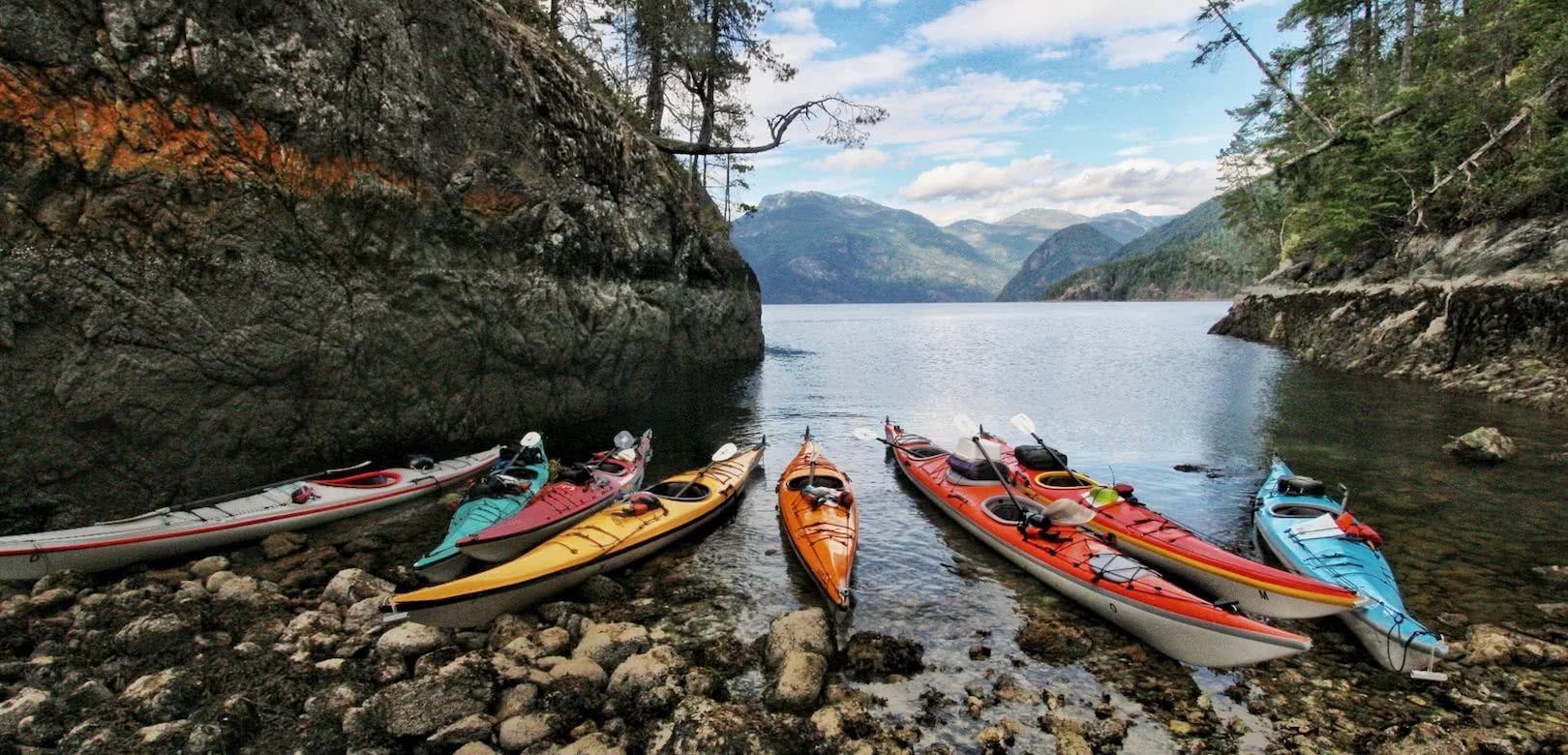 Kayaks at the tide line during a quick break on on of our sea kayak expeditions