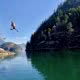 A man swings off a rope swing in Prideaux Haven in Desolation Sound BC