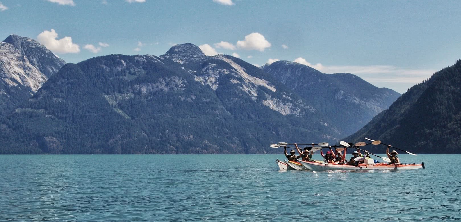 A group of kayakers in Toba Inlet on one of our sea kayak expeditions