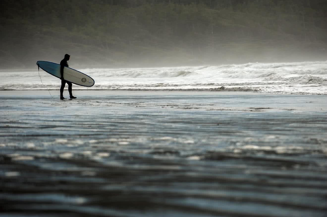 A surfer in a wetsuit in Tofino on Vancouver Island