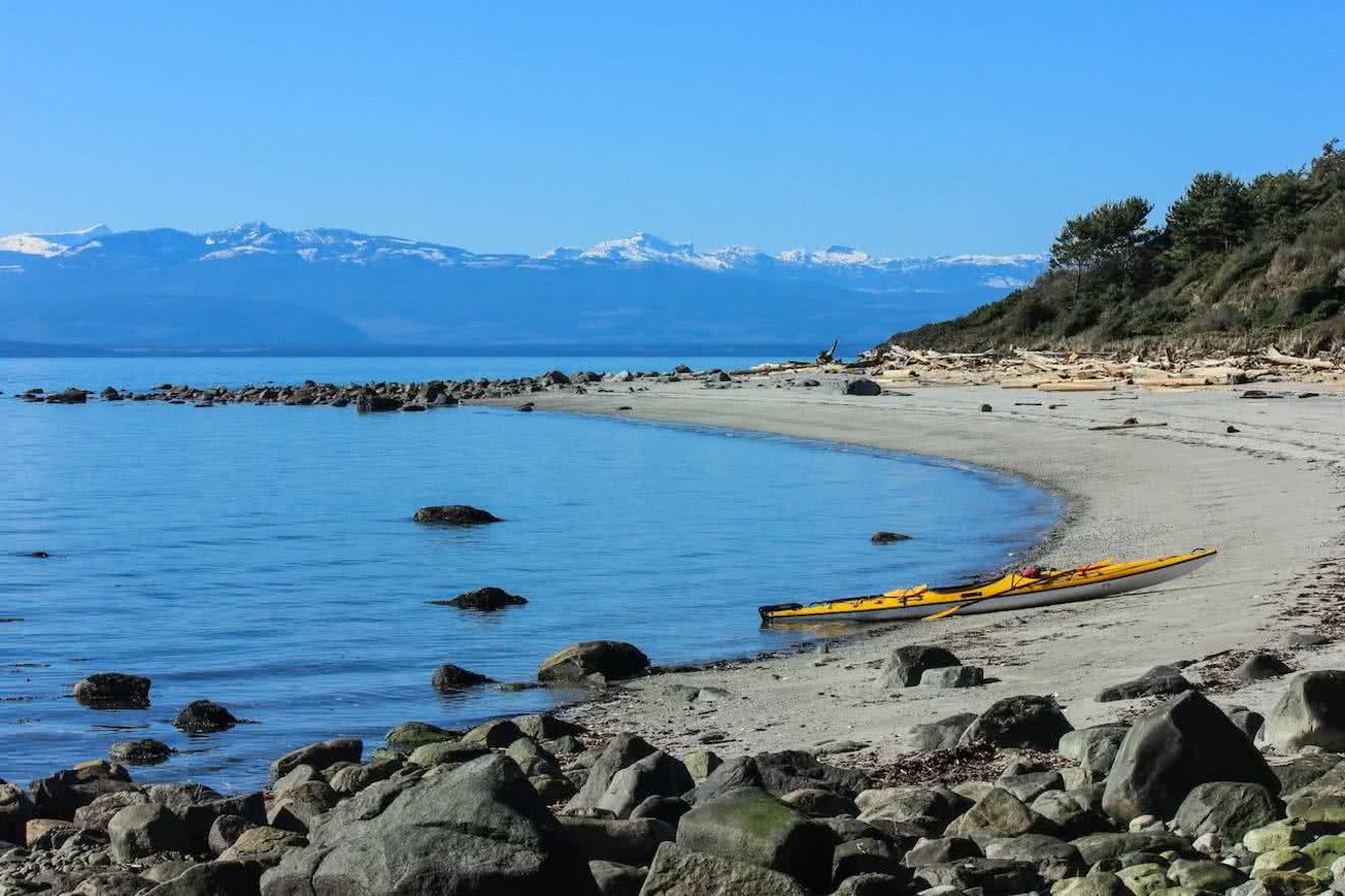 A kayak pulled up on the sandy beach at Duck Bay on Savary Island