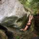 A member of Powell River Climbing Co-op climbs a boulder in the Eldred Valley