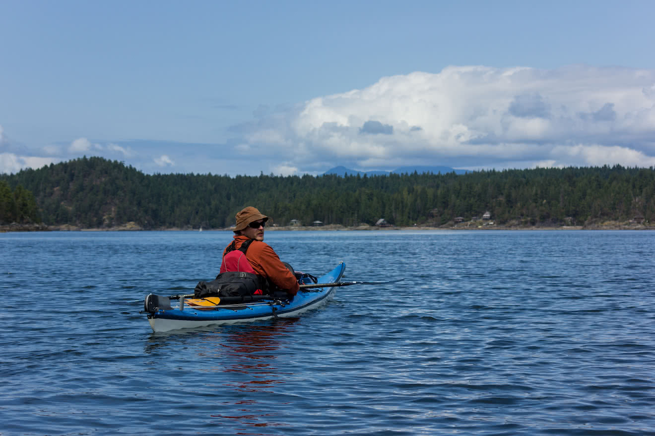 A kayaker in calm Okeover Inlet