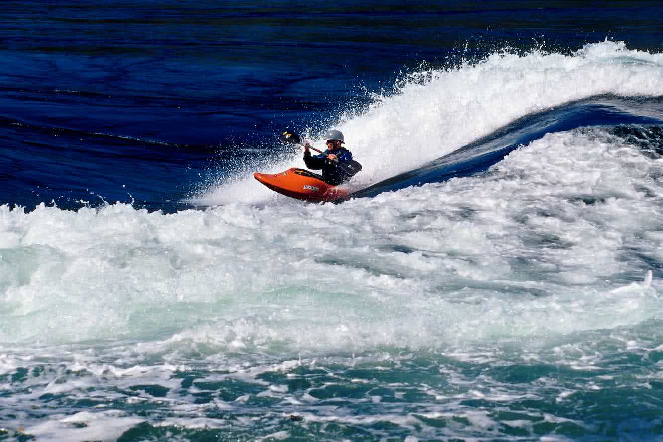 A kayaker surfing the tidal rapids at Skookumchuck on the lower Sunshine Coast