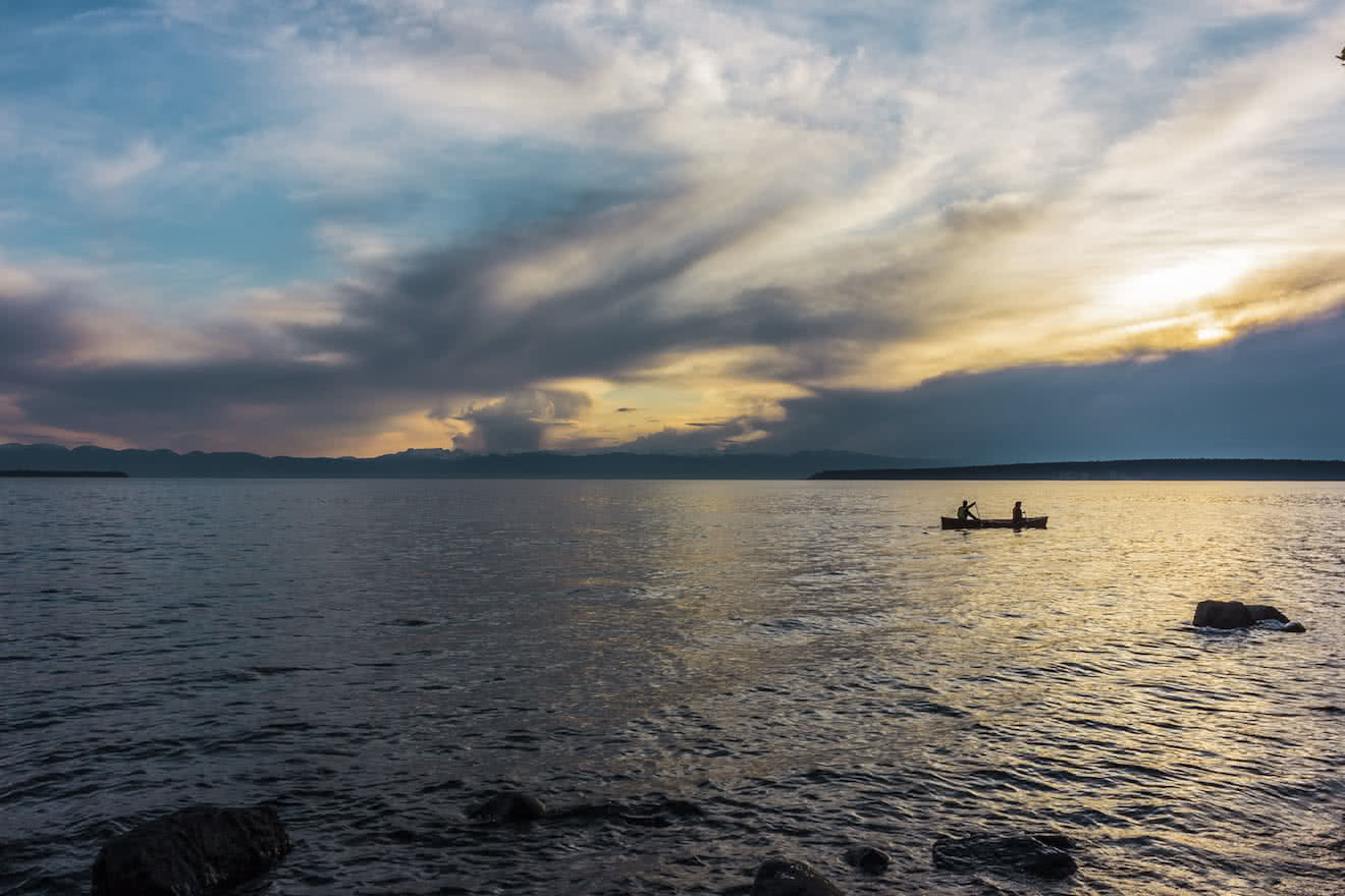 Two canoeists paddling along Powell River beaches