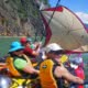 happy kayakers using a sail