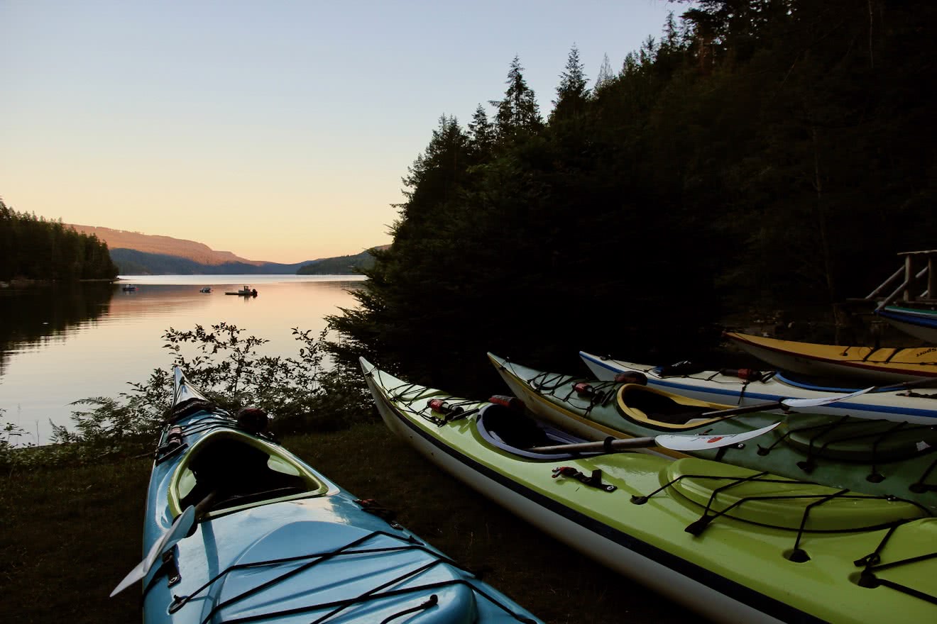 Sea kayaks staged for a day of kayaking in BC in Desolation Sound