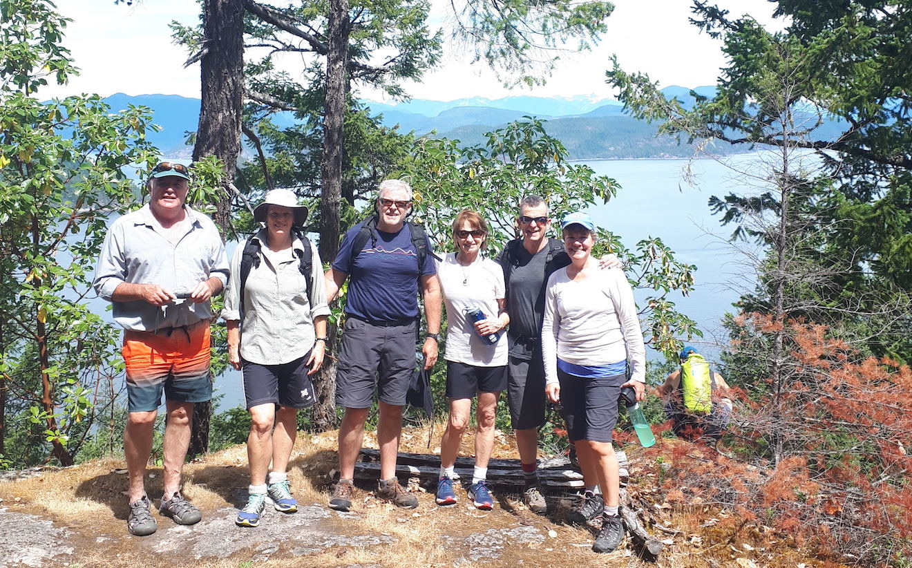 A group at Cabana Desolation Eco Resort standing at the viewpoint of a hike in Desolation Sound