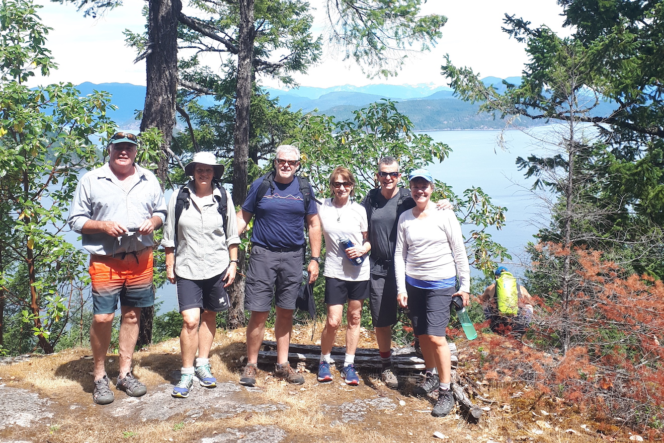 A group at Cabana Desolation Eco Resort standing at the viewpoint of a hike in Desolation Sound