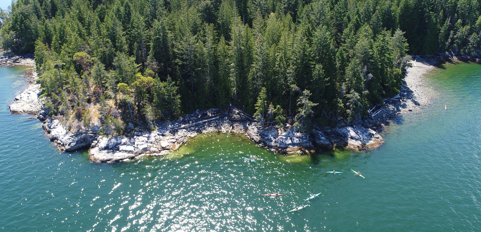 A group of kayakers paddling near Kinghorn Island in Desolation Sound from above