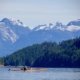 The Coast Mountains are seen by a solo paddler kayaking in Waddington Channel