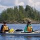 Two paddlers in a double kayak posing for a photo in Malaspina Inlet on one of our kayak tours