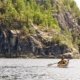 A kayaker paddles towards the photographer in Desolation Sound