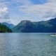 Two paddlers in a double kayak approaching our remote tenured campsite in Toba Inlet