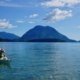 A guide sitting in a kayak at the mouth of Toba Inlet puts on his PFD