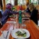 Guests settle down to a meal of seared halibut, soba noodles and local greens at Cabana Desolation