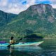 Two paddlers in a double kayak in Pryce Channel with the rugged mainland in the background