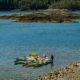 A guide rafts the kayaks together at lunch on a kayak tour in Malaspina Inlet