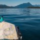 A kayak with a chart of Desolation Sound, and Mount Denman and the Coast Mountains in the background