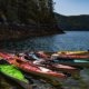 A raft of kayaks tied together and floating off shore in Lewis Channel on a kayak tour