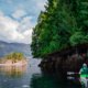 A kayaker looks at the intertidal life on the rocks at low tide as they paddle around Connis Point on West Redonda Island