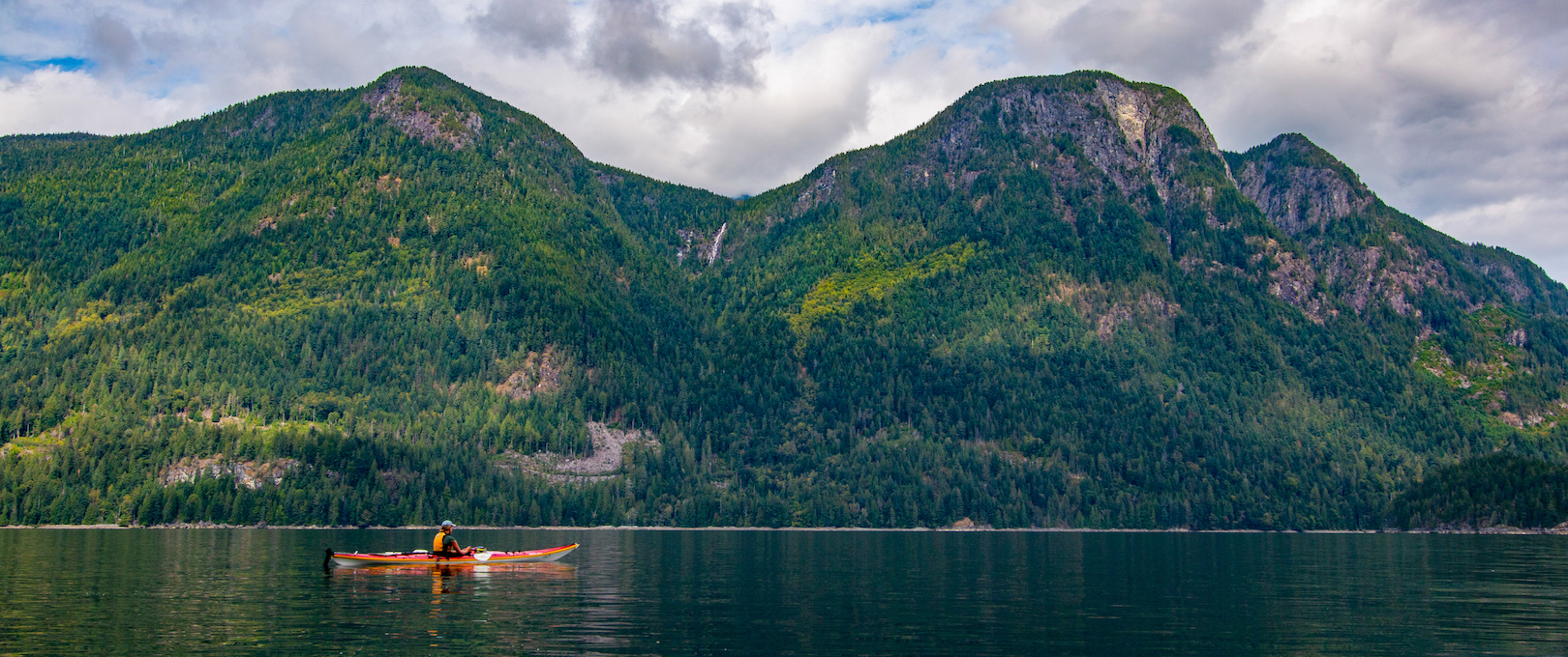 kayaking below the mountains