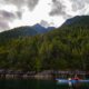 A kayaker paddles past the rugged terrain of the West Redonda Island in Pryce Channel