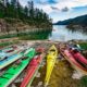 9 kayaks stored about the high tide line in Walsh Cove in northern Waddington Channel on one of our sea kayak expeditions