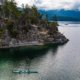 A double kayak starts to paddle away from the Curme Islands in Desolation Sound