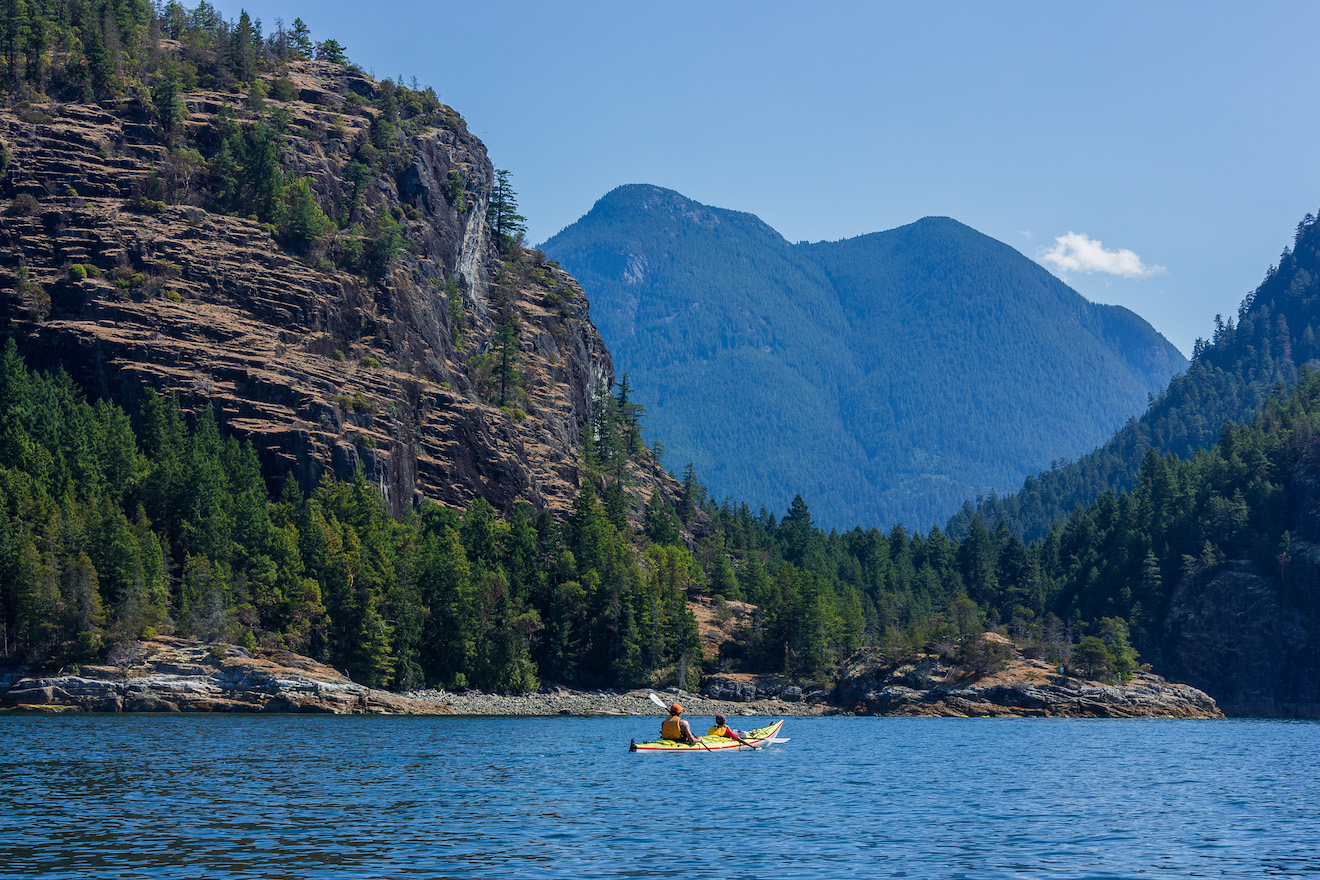 A double kayak passing Bold Head in Desolation Sound Marine Provincial Park