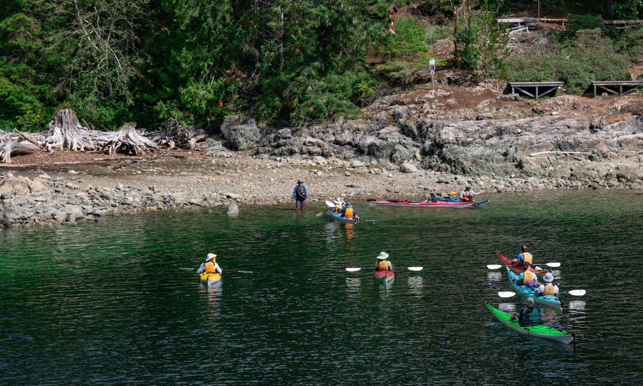 A guided group approaches the campsite at Hare Point in Desolation Sound Marine Provincial Park