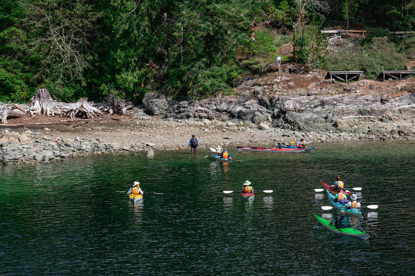 A guided group approaches the campsite at Hare Point in Desolation Sound Marine Provincial Park