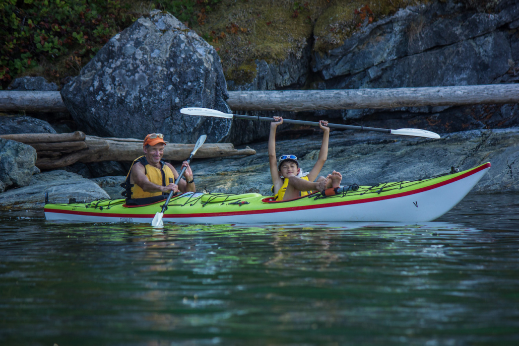 Father and son kayaking in Desolation Sound on a family kayaking trip