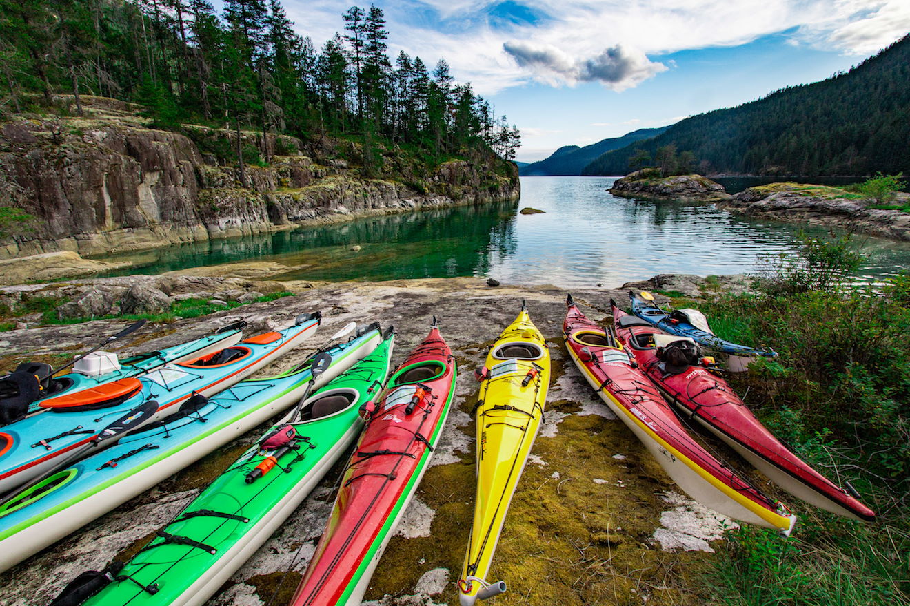 group of multi coloured kayaks